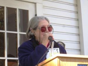 Jackie Rapport at the microphone. Jackie and President Peggy Collins were co-chairmen of the tree planting