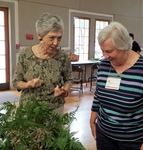 On the left Member Leah D. and Member Darlene L. discuss the use of ferns.
